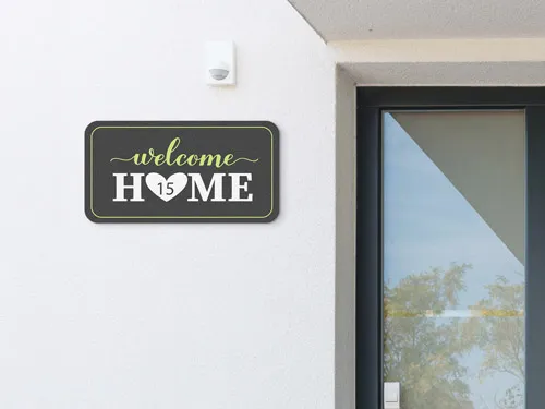 Wooden Welcome Home sign with heart-shaped O featuring the number 15.