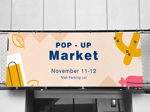 A playful mesh banner reading Pop-Up Market November 11–12 Mall Parking Lot.