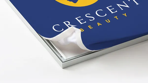 Close-up of a blue SEG fabric with corner peeling to reveal internal pages.