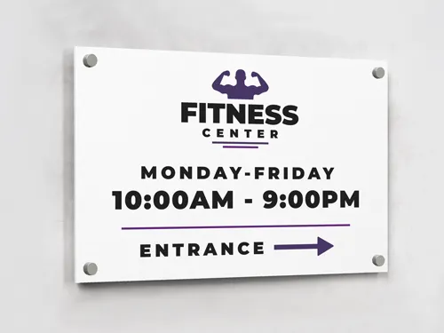 A white fitness center working hours aluminum sign.