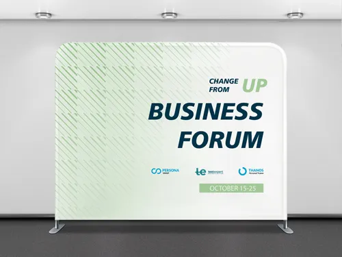 A green and white tension fabric backdrop in a conference environment.