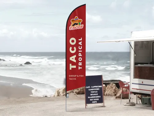 Red feather flag for Taco Tropical restaurant displaying the provided services.
