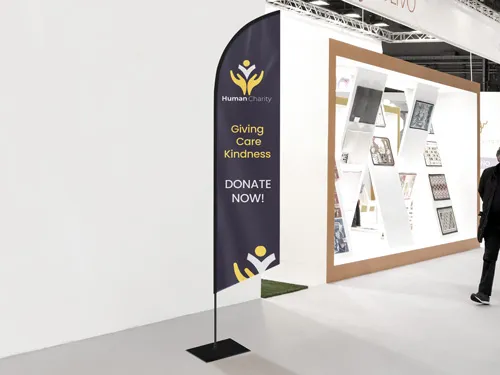 Dark-colored feather flag reading Donate Now with a motivational quote.