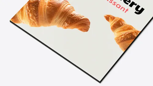 Vibrant foam board sign with a clean light background, showcasing crisp croissant images and partial bakery branding for a fresh, appetizing appeal