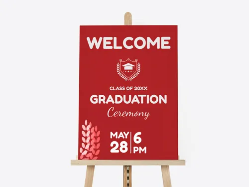 Festive foam board sign with a bold red background, featuring graduation details and white typography, displayed on a wooden easel