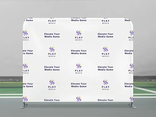 A media tension fabric photo backdrop lined with logos and slogans placed on the sidelines of a soccer pitch.