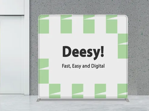 A tension fabric backdrop placed in an office highlighting the brand name and slogan.