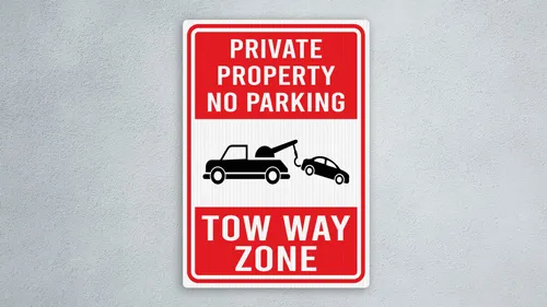 Private Property No Parking Tow-Away Zone sign with truck towing car image.