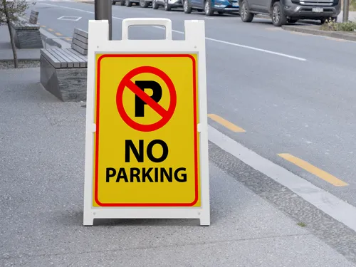 No parking sandwich board with a red P prohibition symbol on a yellow background.