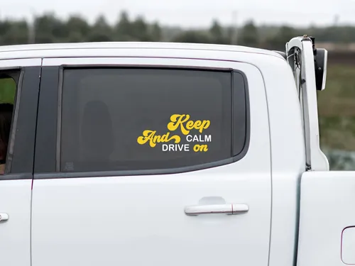 Lettering truck window decals reading a lighthearted quote.