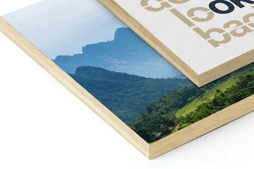 Two wooden prints, one with typography art and the other featuring a scenic mountain view.
