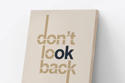 Minimalist beige wooden sign featuring the phrase Don't Look Back in a modern font.