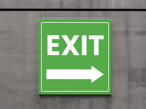 Reflective aluminum sign with a bold green background and white exit text and icon, designed for clear emergency wayfinding